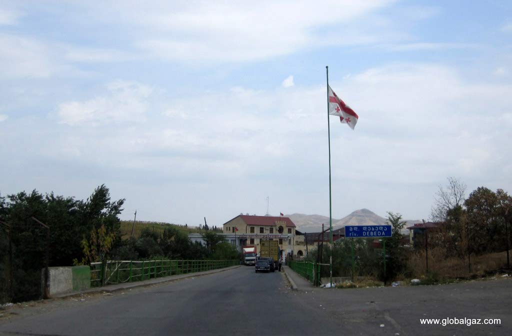 Crossing the border. Georgian flag, with Armenian flag in the background.